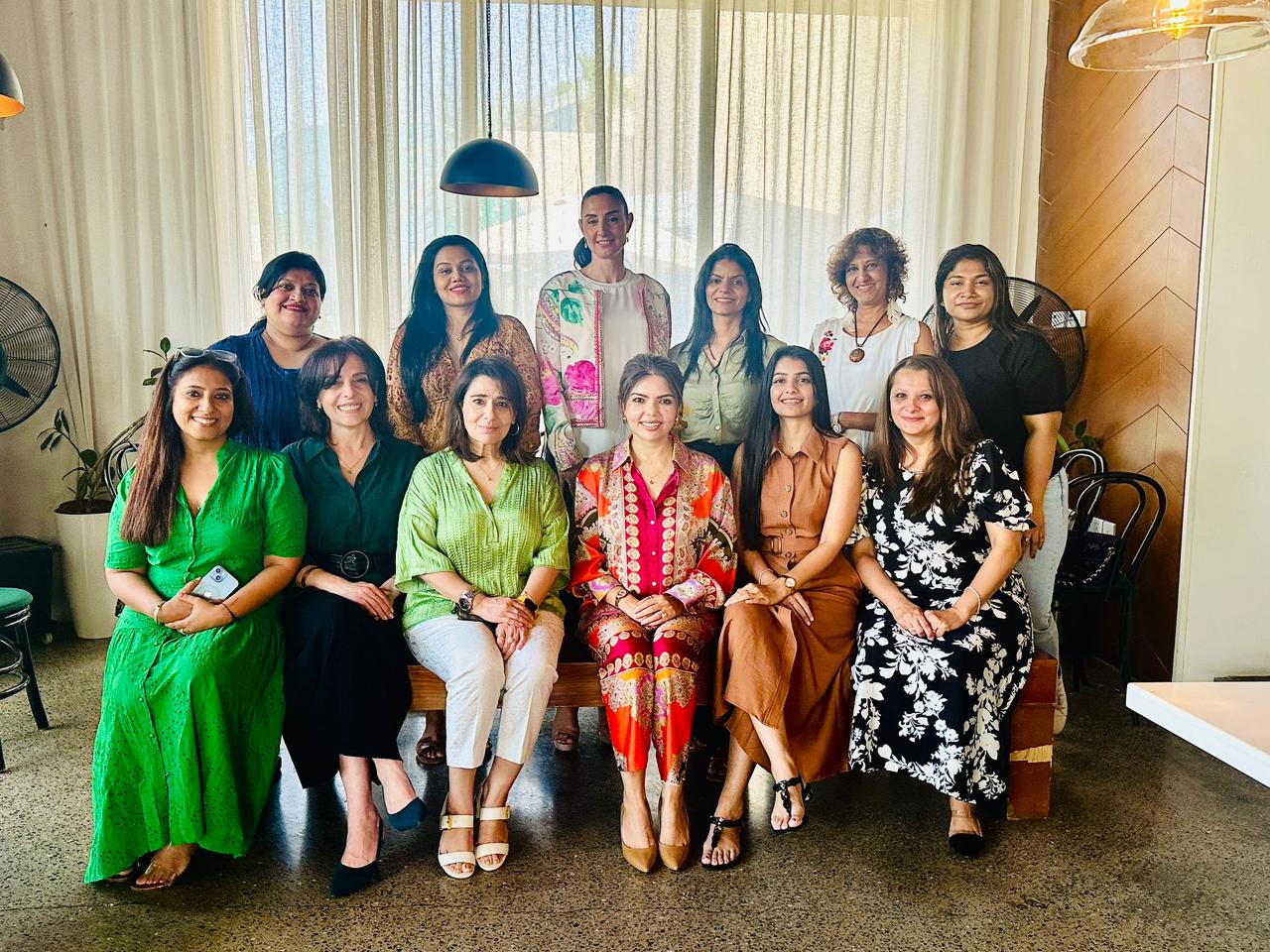 Women attendees smiling and networking during the BeingShe Club Private Circle Dubai event.